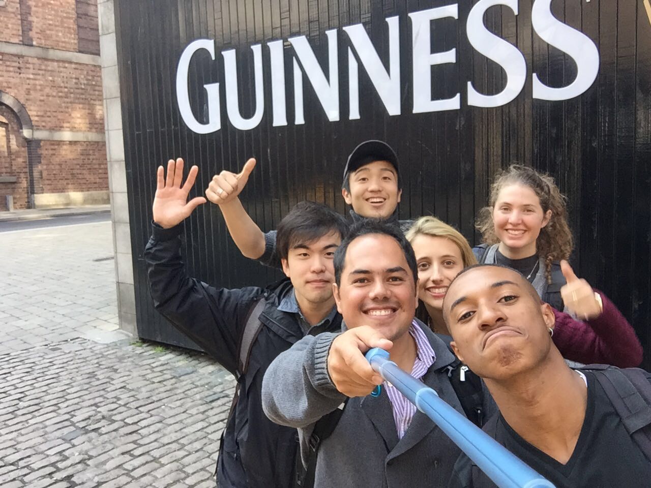 students smiling and taking a selfie with the guiness factory sign dublin