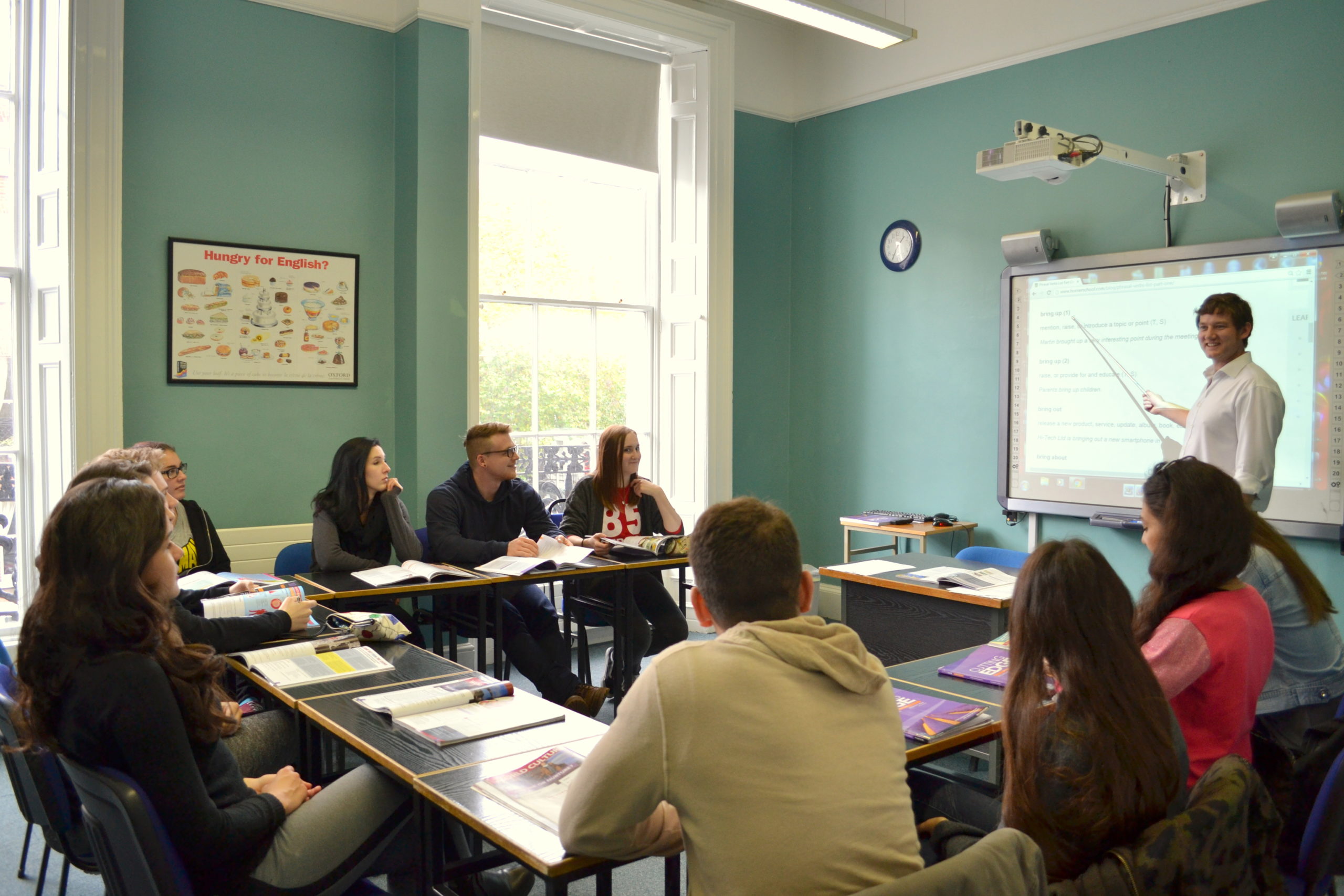 teacher teaching an english class to students in horner school