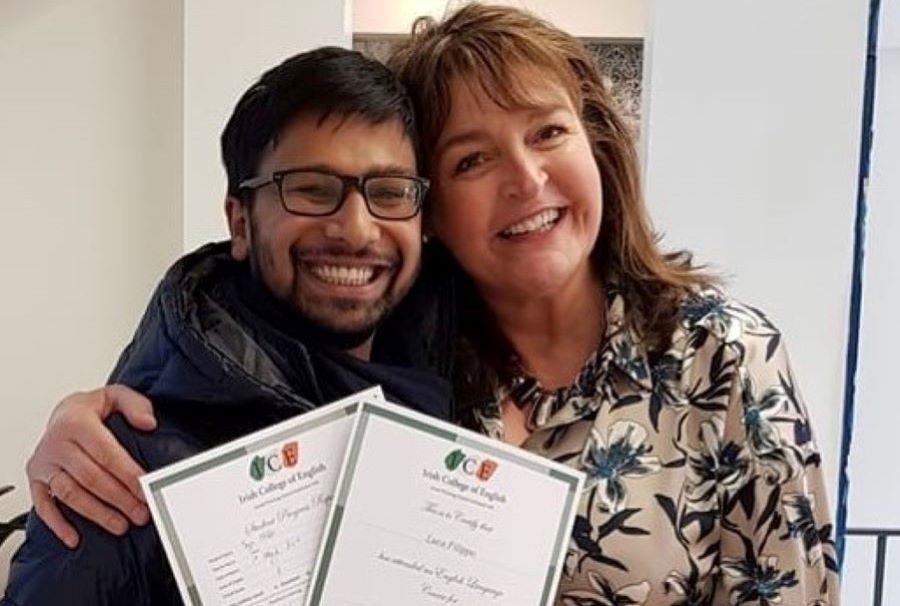 english language student and teacher hug and smile with course certificates