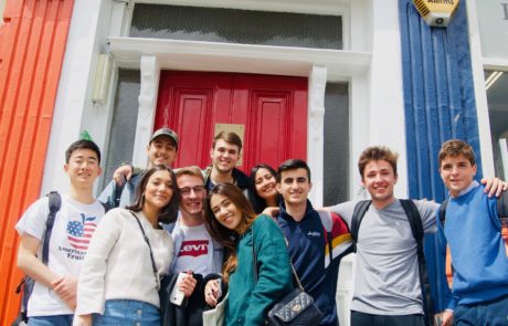 students smile and post outside the door of avanti language institute
