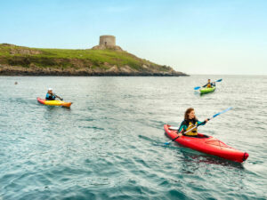 Two people taking part in one of the many water activities Ireland has to offer English Language Students, kayaking at Dalkey Islands.