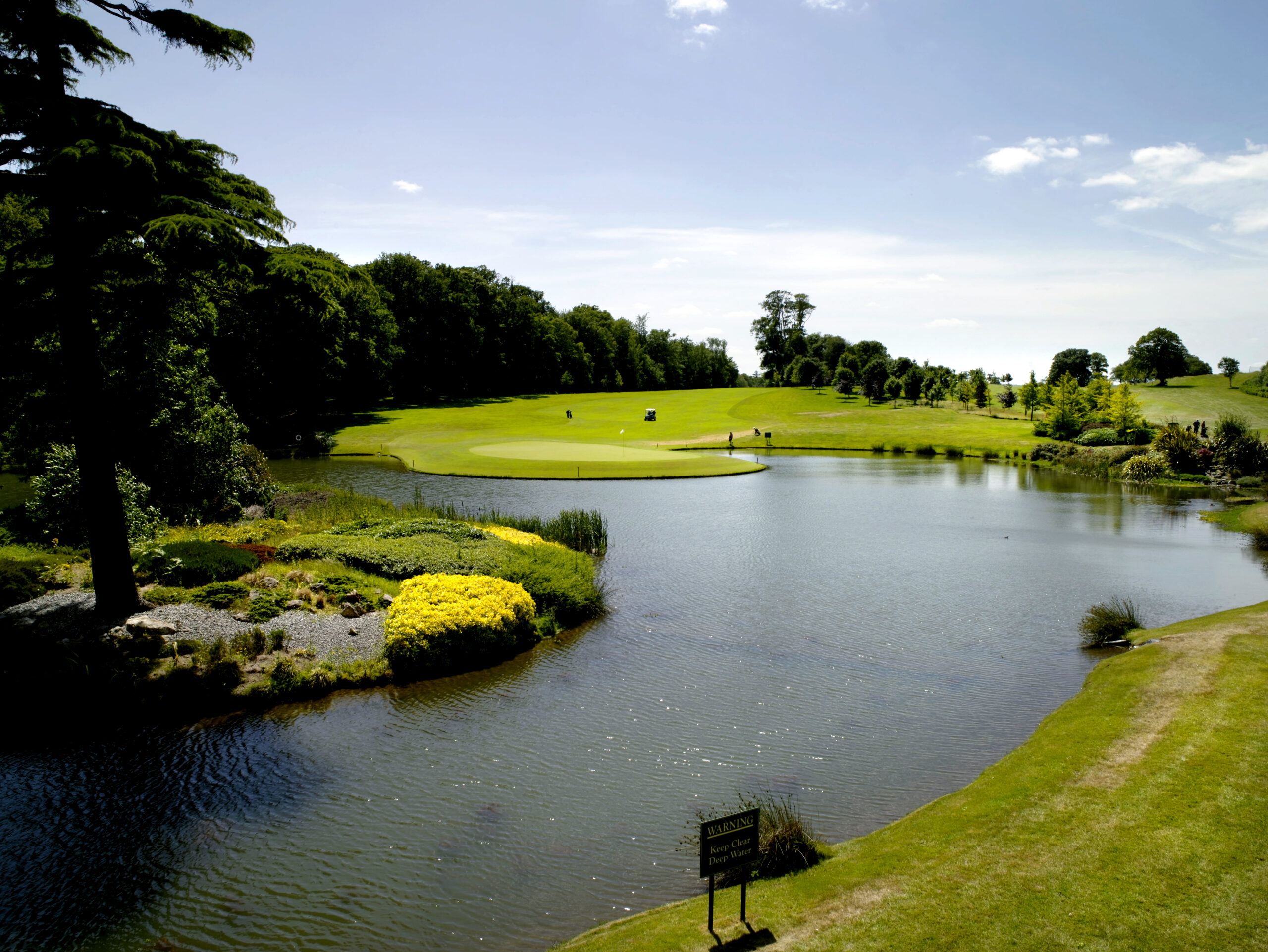 Fota island resort, a view of a lake, bright green grass and trees.